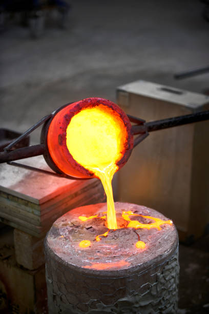 istock Artist fills mold with molten bronze 643932290