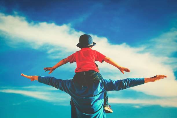 istock happy father and son playing on sky 643937510