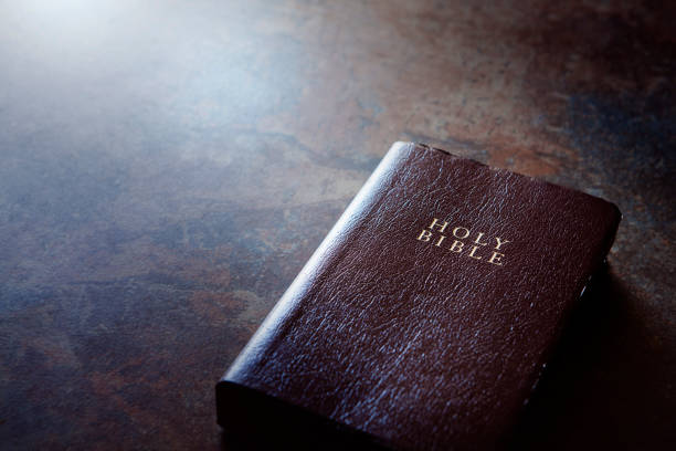 istock Bible is laying on the brown table 643942112