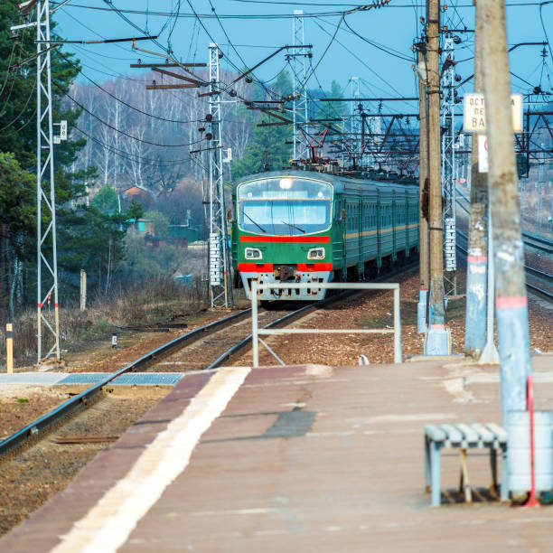 Russian suburban passenger train arriving to rural station