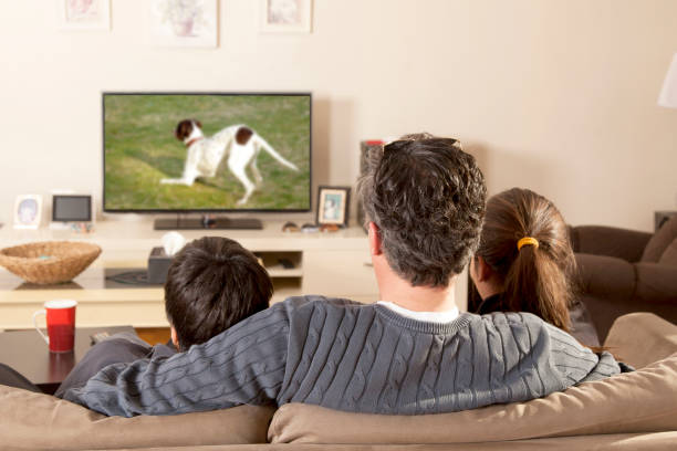 istock family watchin tv 643947242