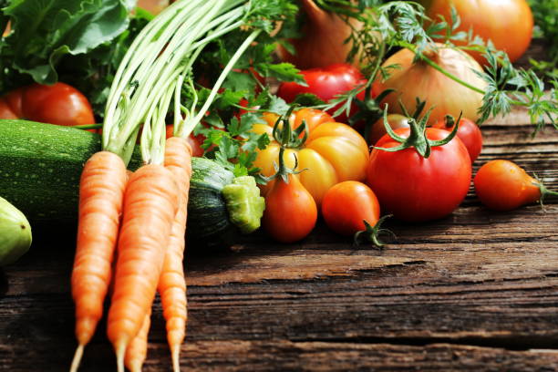 istock Vegetables and herbs on wooden background. 643949650