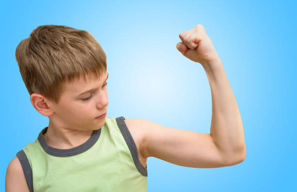 istock Boy looking at the bicep muscle 643950038
