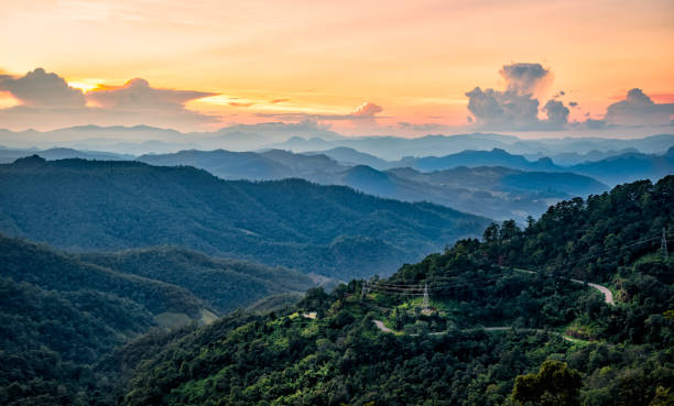 istock Road with layer of mountains and mist at twilight time 643951016