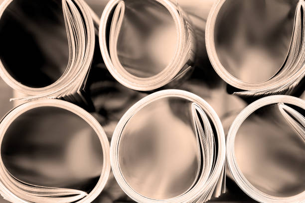 istock edge of  magazine stacking roll with  blurry bookshelf background 643956692