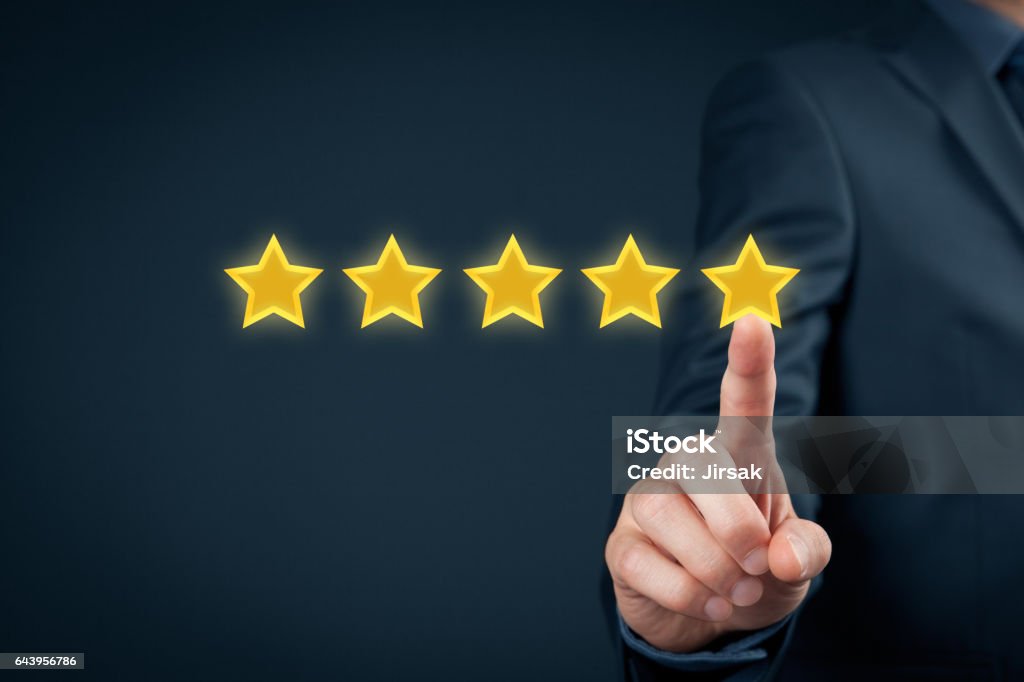 Review concept Review, increase rating or ranking, evaluation and classification concept. Businessman click on five yellow stars to increase rating of his company."n First Class Stock Photo