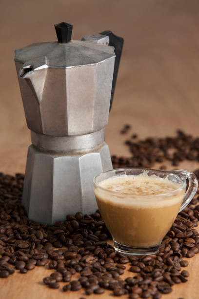 istock Coffee beans with metallic coffee maker and coffee cup 643957564