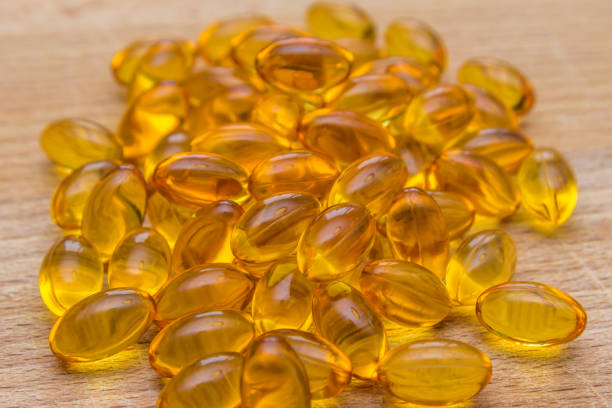 Fish oil capsules Fish oil tablets packed with omega 3 eicosapentaenoic acid stock pictures, royalty-free photos & images