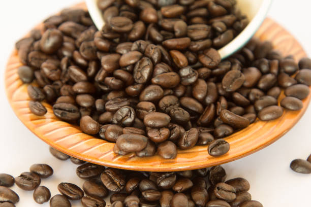 istock Coffee bean in a brown dish on white background. 643957996