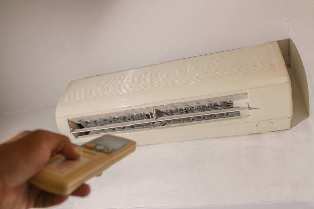 istock Closeup remote control Air conditioner for cooling, energy saving To reduce global warming concept idea. 643961024