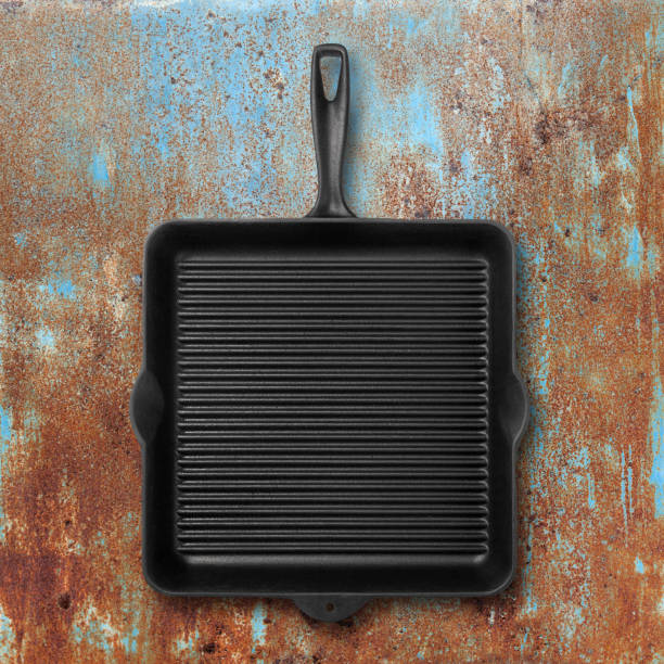 Grill pan on grunge metal background