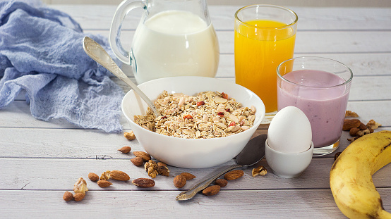 Healthy Breakfast table with muesli, egg, smoothie