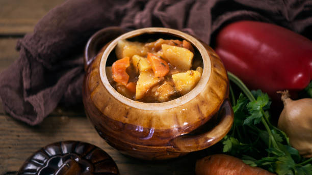 istock Vegetable and meat stew in crock with raw fresh vegetables 643972956