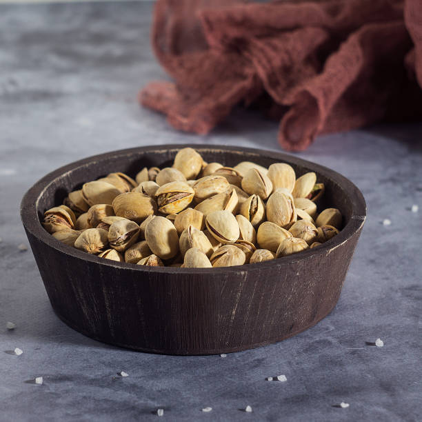 istock Pistachios in a wooden spoon. Selective focus 643973872