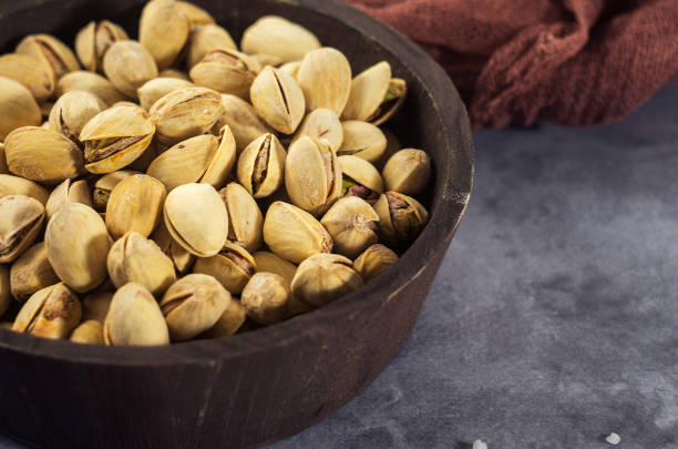 istock Pistachios in a wooden spoon. Selective focus. Close up 643973880