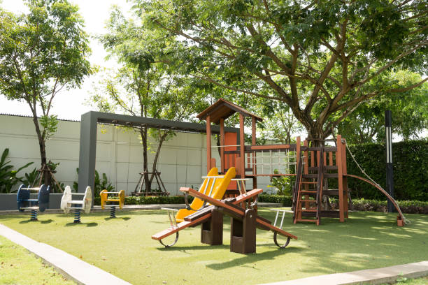 Set of children playground Set of children playground under big tree in the park. swing play equipment photos stock pictures, royalty-free photos & images