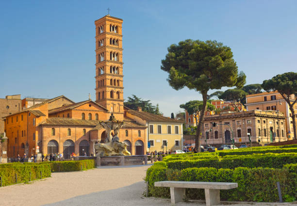 Santa Maria in Cosmedin church and fountain in Rome, Italy Rome, Italy - March 29, 2014: Piazza della Bocca della Verita with fountain and church Santa Maria in Cosmedin triton greek god stock pictures, royalty-free photos & images