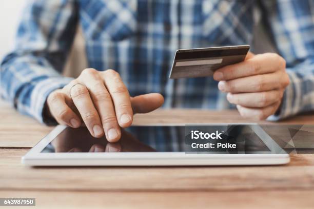 Man Shopping Online With Digital Tablet And Credit Card Stock Photo - Download Image Now
