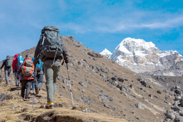 istock People walking up in Mountains with Backpacks 643991010