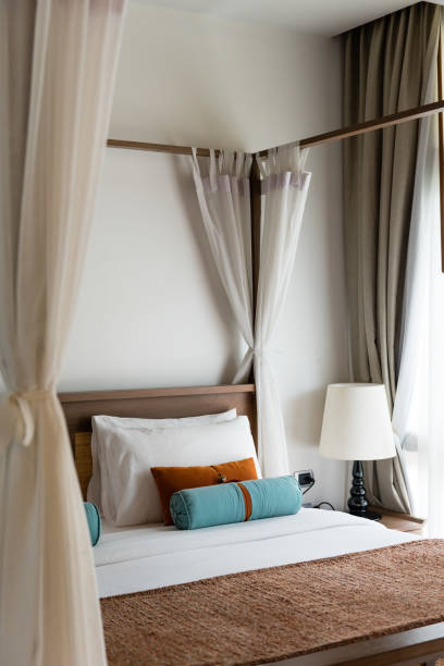 istock resort style bedroom with white sheet, brown and blue pillow 643991220