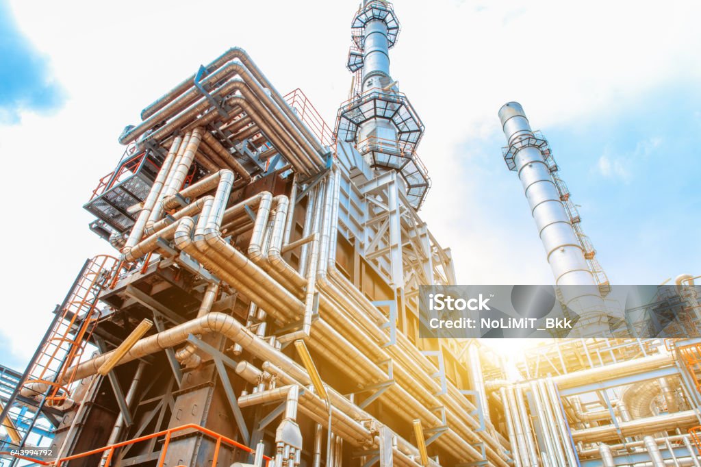 Petrochemical Refinery oil and gas industry Petrochemical oil refinery, Refinery oil and gas industry, The equipment of oil refining, Close-up of Pipelines and petrochemical industrial plant towers view of oil and gas refinery Refinery Stock Photo