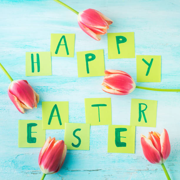 istock Happy Easter background tulips flowers hand written letters 643995628