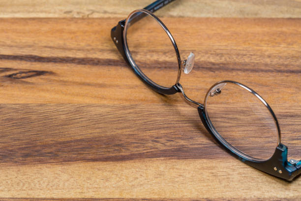 istock Eyeglasses On Wooden Desk 643996230