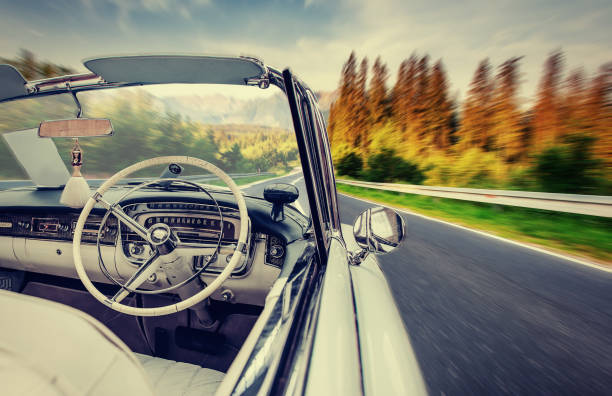 istock Fantastic asphalt road in the mountains. Classic car 643996240