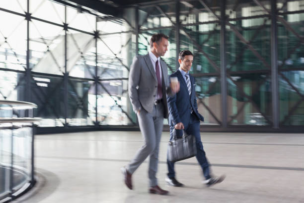 istock Corporate businessmen walking in modern lobby 643998767