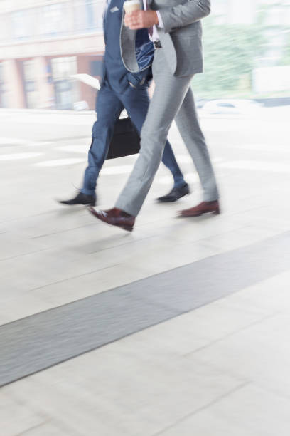 istock Corporate businessmen walking with coffee 643998863