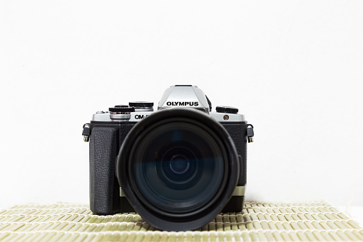Close up of DSLR or digital camera isolated on white background. Brand Olympus OMD-EM10 MK I made in Japan, Feb 9, 2017
