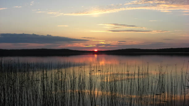 istock Karelia sunset on the lake in the woods. 644005472
