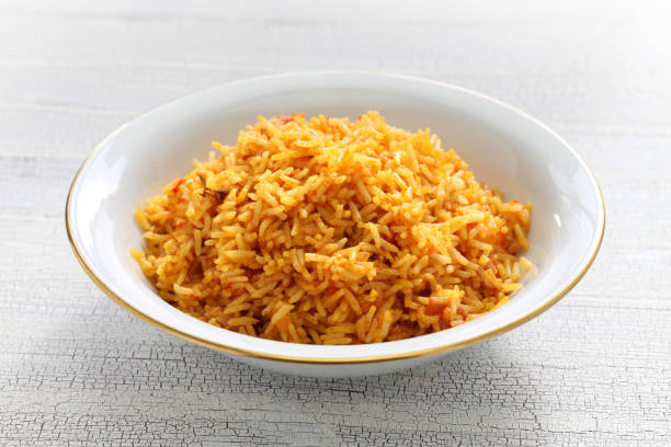jollof rice with chicken and fried plantain, west african cuisine jollof rice with chicken and fried plantain, west african cuisine tomato rice stock pictures, royalty-free photos & images