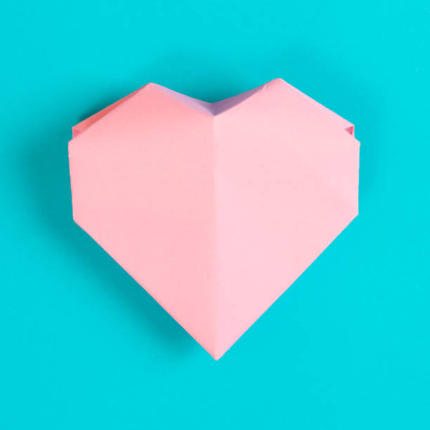 istock Pink Paper Origami Heart On Turqoise Background 644025548