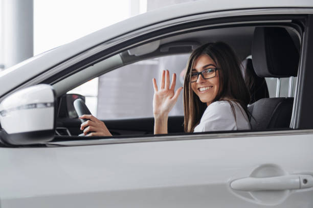 istock Pretty young woman driving new car. 644035176