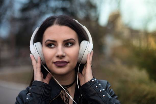istock Young beautiful woman with headphones 644040856