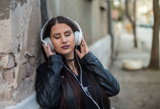istock Young beautiful woman with headphones 644045504