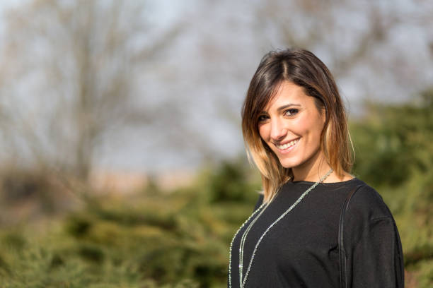 istock Beautiful young woman in a park 644051470