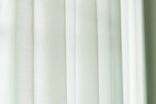 istock close up green curtain with sunlight for background 644054290