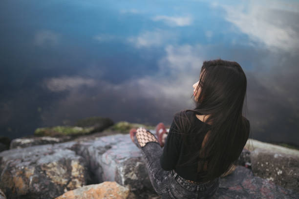 istock Young woman relaxes looking away 644054816
