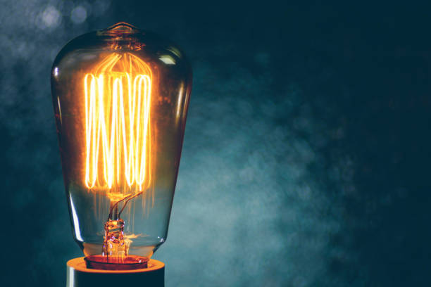 istock Macro vintage light bulb filament, bokeh light background 644057516