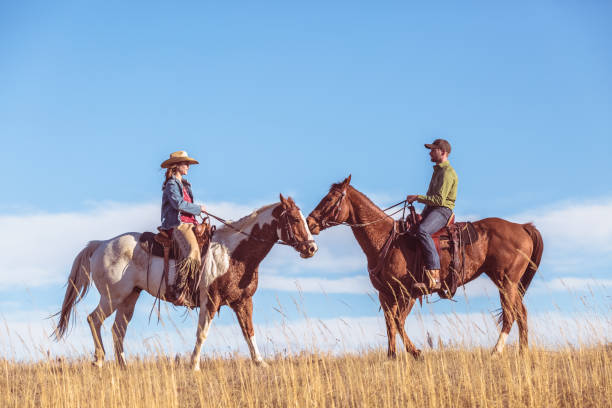istock Two People On Horseback Riding Toward Each Other 644060870