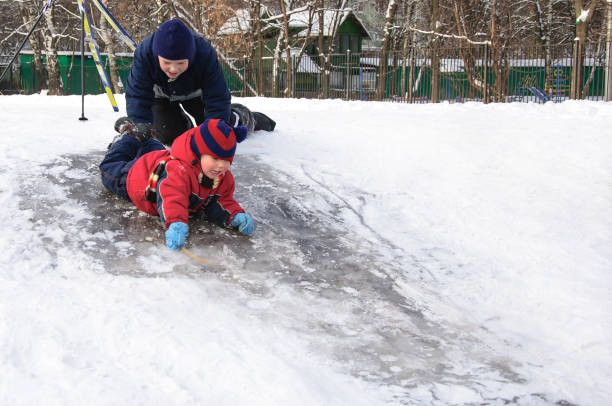 istock Happy children sliding from a little snowy hill. 644066444