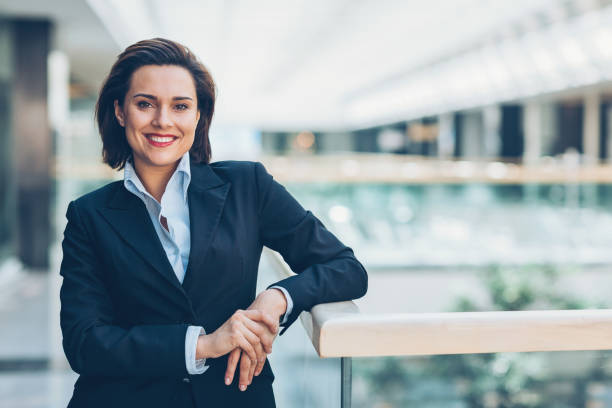 Independence and success in business Smiling young businesswoman standing confidently inside of a modern office building, with copy space female lawyer stock pictures, royalty-free photos & images