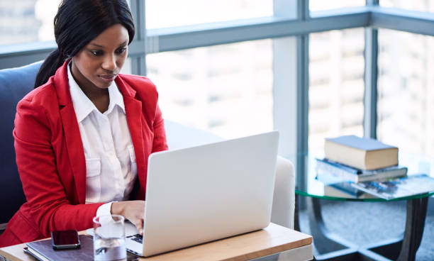 istock black businesswoman busy working while looking at her computer screen 644083552