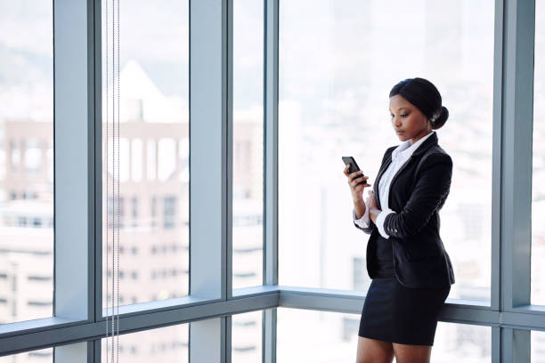 istock Mature black business woman texting while standing 644083570