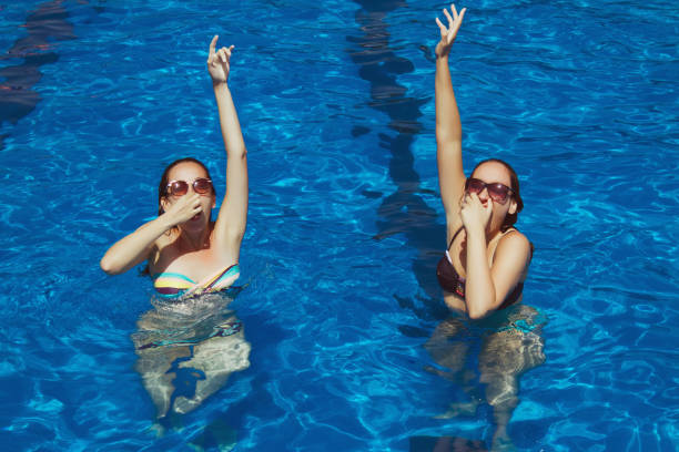 istock Two young women having fun on swimming pool 644083808