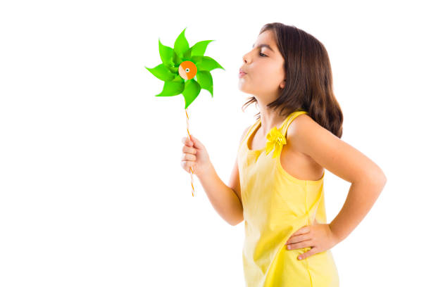 Beautiful girl blowing a plastic windmill