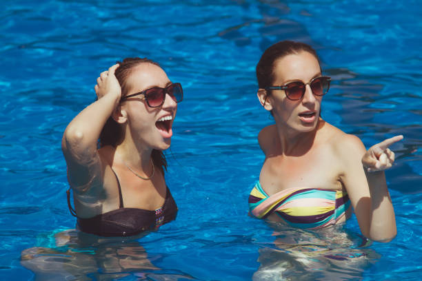 istock Two young women having fun on swimming pool 644086642