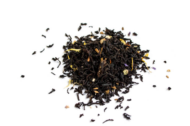 istock Black tea leaf with flower on white background 644089318